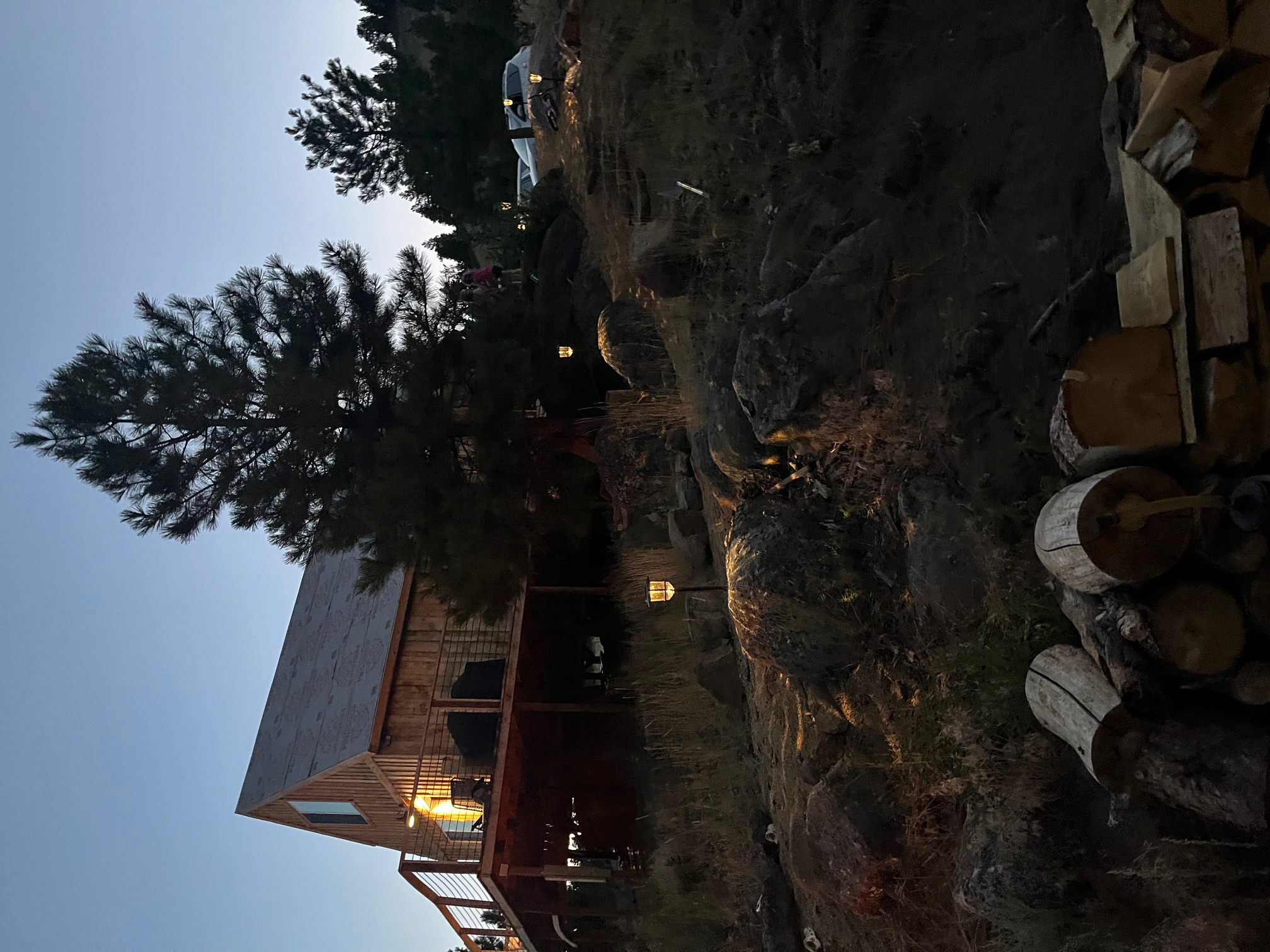Ranch lodge cabin at dusk surrounded by pine trees on the Montana training facility
