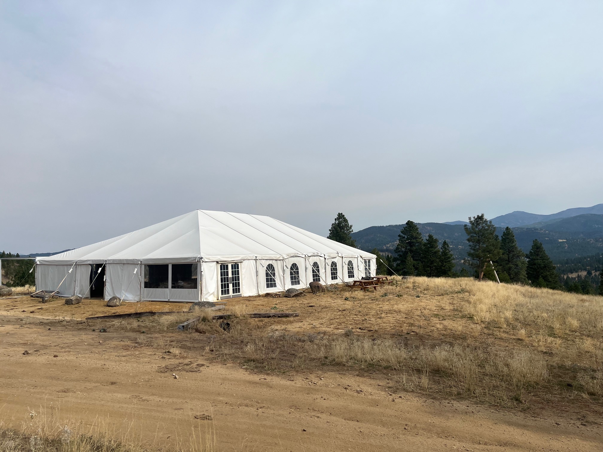 Training facility tent structure with Montana mountain backdrop for electronic warfare instruction